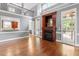 Large, open living area with fireplace, hardwood floors, and lots of natural light at 121 Cobblepoint Way, Holly Springs, NC 27540