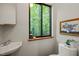 Cozy powder room features a sink, toilet and beautiful views of the outdoor scenery at 1213 Blackwood Mountain Rd, Chapel Hill, NC 27516