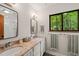 Bathroom features double vanity with granite counters and views of nature through a large window at 1213 Blackwood Mountain Rd, Chapel Hill, NC 27516