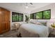 Comfortable bedroom features wood-look floors, lots of natural light, and a serene nature view at 1213 Blackwood Mountain Rd, Chapel Hill, NC 27516