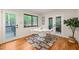 Dining area with a white table and chairs next to a window with peaceful views and access to the deck at 1213 Blackwood Mountain Rd, Chapel Hill, NC 27516