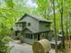 Exterior side view of the home in the woods that has a hot tub and a barrel sauna at 1213 Blackwood Mountain Rd, Chapel Hill, NC 27516