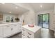 Kitchen features white cabinets, stainless steel appliances, an island, and access to the dining area at 1213 Blackwood Mountain Rd, Chapel Hill, NC 27516