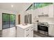 The modern kitchen features an island, stainless steel appliances, and access to the backyard deck at 1213 Blackwood Mountain Rd, Chapel Hill, NC 27516