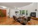 Cozy living room with a fireplace, comfortable seating, and natural light from multiple windows at 1213 Blackwood Mountain Rd, Chapel Hill, NC 27516