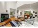 Open-concept living room with a fireplace, dining area, and ample natural light at 1213 Blackwood Mountain Rd, Chapel Hill, NC 27516