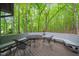Seating area with built in benches, chairs and a table. Overlooks a dense forest at 1213 Blackwood Mountain Rd, Chapel Hill, NC 27516
