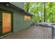 View of the patio that has outdoor seating and looks out to a dense forest at 1213 Blackwood Mountain Rd, Chapel Hill, NC 27516