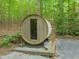 Barrel-shaped outdoor sauna with a glass front door located on a mulch bed at 1213 Blackwood Mountain Rd, Chapel Hill, NC 27516