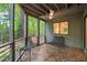 Inviting screened porch with brick flooring and peaceful view of the surrounding forest at 1213 Blackwood Mountain Rd, Chapel Hill, NC 27516