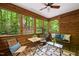 Inviting screened porch features rustic wood walls and a beautiful forest view at 1213 Blackwood Mountain Rd, Chapel Hill, NC 27516
