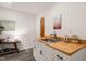 This wet bar features white cabinets, butcher block countertop, sink, and stylish decor to elevate the space at 1213 Blackwood Mountain Rd, Chapel Hill, NC 27516