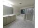 Bright, spacious bathroom featuring double vanities, soaking tub, and walk-in glass shower at 1240 Grenshaw Dr, Morrisville, NC 27560