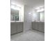 Bright, spacious bathroom featuring double vanities and stylish tile flooring at 1240 Grenshaw Dr, Morrisville, NC 27560