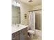 Well-lit bathroom featuring a toilet, sink with vanity, a shower and an attractive tile floor at 1240 Grenshaw Dr, Morrisville, NC 27560