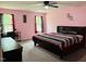 Inviting bedroom with large bed, side table, dresser, and windows with privacy enhancing curtains at 1240 Grenshaw Dr, Morrisville, NC 27560