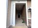 Covered entryway featuring modern lighting and natural brick accents at 1240 Grenshaw Dr, Morrisville, NC 27560