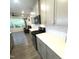 Modern kitchen featuring white cabinets, quartz countertops, stainless steel appliances, and herringbone tile backsplash at 1240 Grenshaw Dr, Morrisville, NC 27560