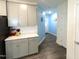 Bright kitchen featuring grey cabinets, white quartz countertops, and wood floors at 1240 Grenshaw Dr, Morrisville, NC 27560