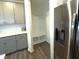 View of kitchen cabinets, quartz countertops, backsplash, and mudroom area at 1240 Grenshaw Dr, Morrisville, NC 27560