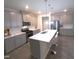 Modern kitchen with gray cabinets, stainless steel appliances, and a spacious island at 1240 Grenshaw Dr, Morrisville, NC 27560