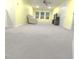 Large, open living area with neutral carpet, bright yellow walls and large windows for natural light at 1240 Grenshaw Dr, Morrisville, NC 27560