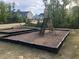 Community playground, showcasing a slide and other playground features, as well as some nearby homes at 1240 Grenshaw Dr, Morrisville, NC 27560