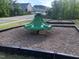 Community playground equipment with a merry-go-round and other playground features for children at 1240 Grenshaw Dr, Morrisville, NC 27560