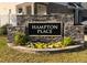 Stone sign with the name of the Hampton Place community surrounded by flowers at 1240 Grenshaw Dr, Morrisville, NC 27560