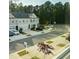 Street view of modern townhomes with attached garages, lush landscaping, and plenty of parking at 1240 Grenshaw Dr, Morrisville, NC 27560