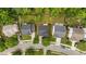 Aerial view showcases neighborhood with lush lawns, mature trees, and easy street access at 125 Occidental Dr, Holly Springs, NC 27540