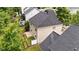 Aerial view of the home's backyard, showcasing the patio, landscaping, and surrounding neighborhood at 125 Occidental Dr, Holly Springs, NC 27540