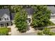 A residential property with mature shade trees and two-car driveway; convenient street access at 125 Occidental Dr, Holly Springs, NC 27540