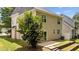 An ample-sized backyard with a sliding glass door leading to a patio and landscaped, terraced garden at 125 Occidental Dr, Holly Springs, NC 27540