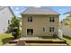 Spacious backyard featuring a sliding glass door leading to a patio and landscaped terraced garden at 125 Occidental Dr, Holly Springs, NC 27540
