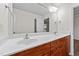 Bathroom vanity features dual sinks, a white countertop, and a wood-tone cabinet at 125 Occidental Dr, Holly Springs, NC 27540
