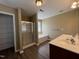 Bathroom with double vanity, soaking tub, glass-enclosed shower and linen closet at 125 Occidental Dr, Holly Springs, NC 27540