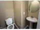 Cozy half bathroom featuring a pedestal sink, toilet, and neutral wall paint at 125 Occidental Dr, Holly Springs, NC 27540