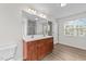 Bathroom featuring a double vanity, modern fixtures, and wood-look flooring at 125 Occidental Dr, Holly Springs, NC 27540