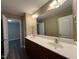 A bathroom featuring a double sink vanity with a mirror at 125 Occidental Dr, Holly Springs, NC 27540