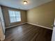 Bedroom with modern flooring, window and neutral paint at 125 Occidental Dr, Holly Springs, NC 27540
