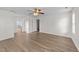 Large open bedroom with hardwood floors, a ceiling fan, and access to an ensuite at 125 Occidental Dr, Holly Springs, NC 27540