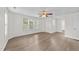 Bedroom with hardwood floors, a window, and neutral walls with a ceiling fan at 125 Occidental Dr, Holly Springs, NC 27540
