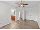 Large bedroom with hardwood floors adjacent to an ensuite bathroom and walk-in closet at 125 Occidental Dr, Holly Springs, NC 27540