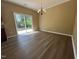 Open dining area featuring modern flooring, neutral colors, and a sliding glass door at 125 Occidental Dr, Holly Springs, NC 27540