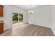 Dining area with modern light fixture and sliding glass doors to the backyard at 125 Occidental Dr, Holly Springs, NC 27540