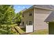 Home exterior featuring a patio, well maintained backyard, and natural landscaping at 125 Occidental Dr, Holly Springs, NC 27540