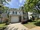 Charming two-story home with a garage, landscaped yard, and classic architectural details at 125 Occidental Dr, Holly Springs, NC 27540