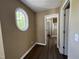 Hallway with access to bathroom, closet, and bedroom with oval window at 125 Occidental Dr, Holly Springs, NC 27540