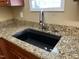 Close up on a kitchen sink with granite countertop and stylish faucet at 125 Occidental Dr, Holly Springs, NC 27540